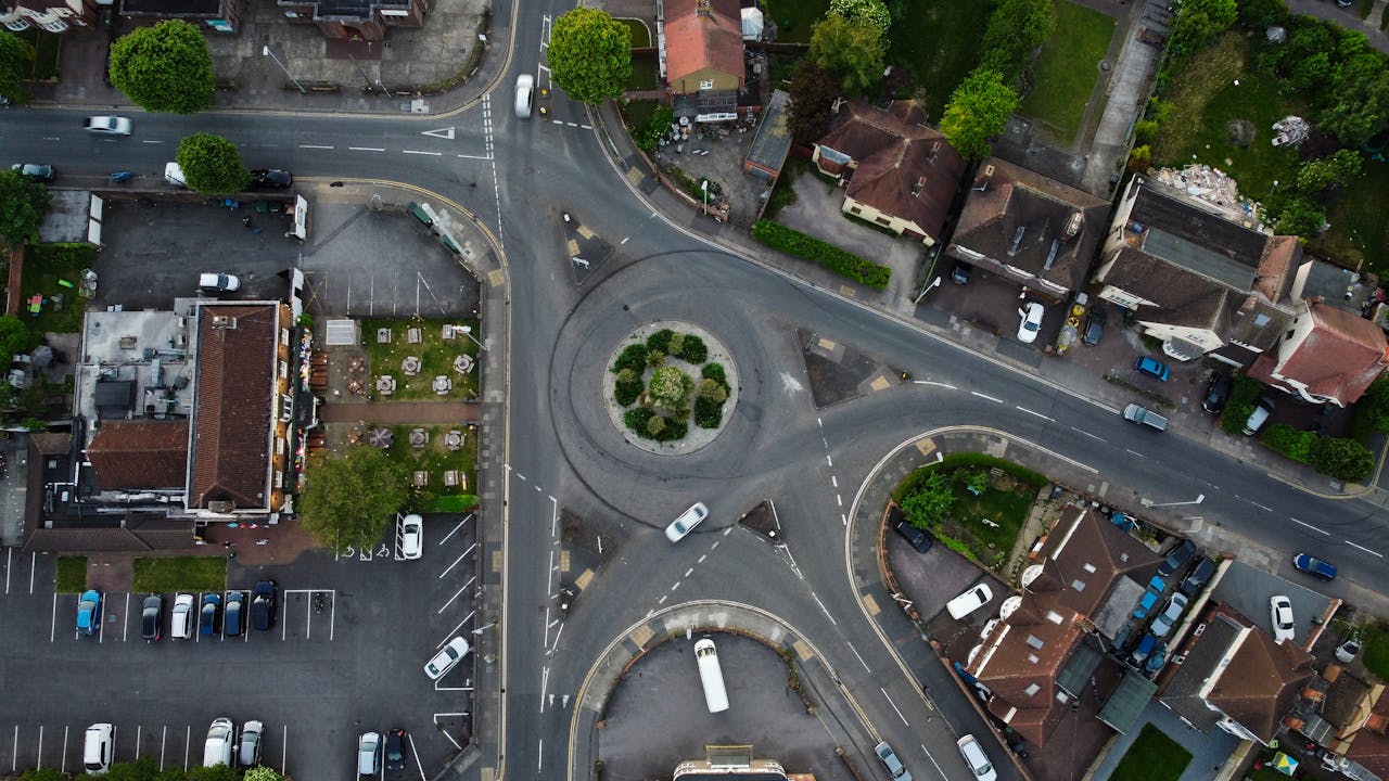 Aerial shot of a roundabout in Luton, England, showcasing urban roads and vehicles.